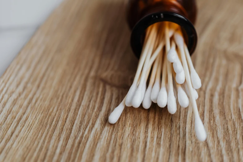 sticks are in a bottle on top of a table