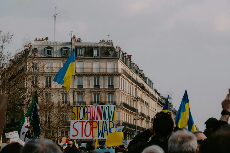 several people are standing near each other and holding signs