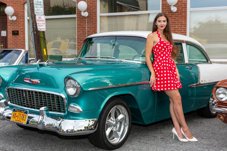 a woman is leaning on the side of a car