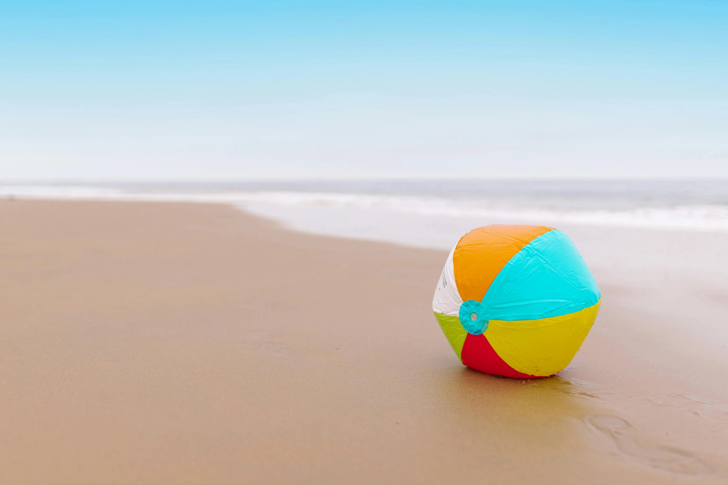 a beach ball is laying on the beach