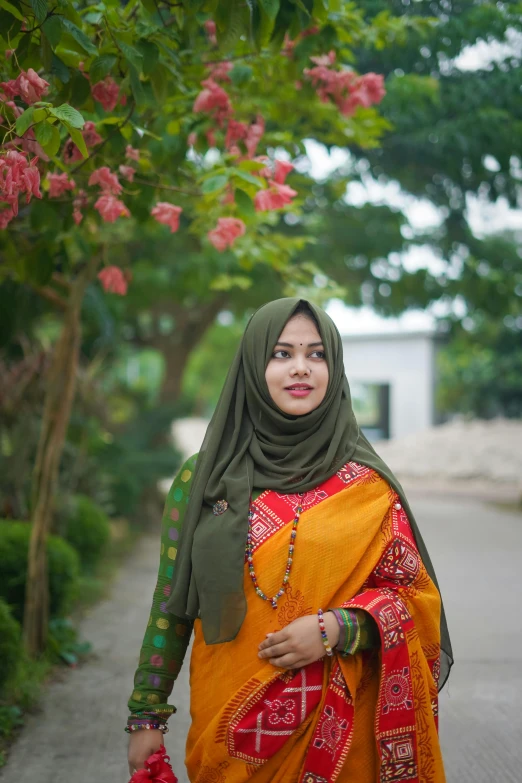 a woman walking on a path in a scarf