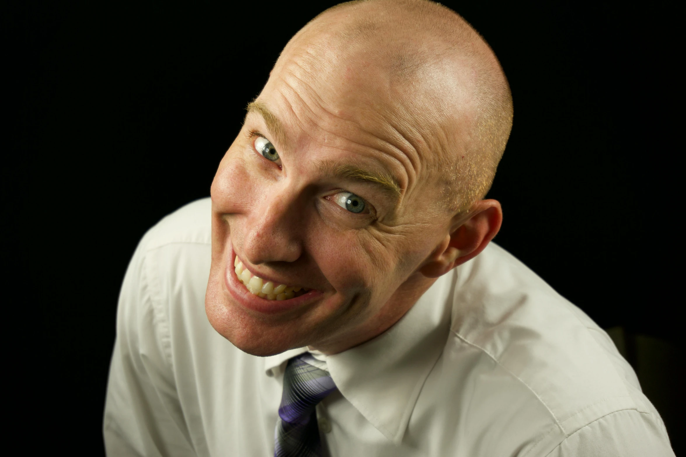 an old man in white shirt and tie with a smile on his face