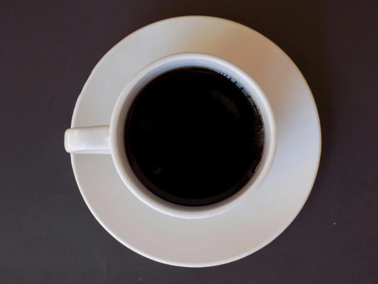 a close up of a coffee cup with the top slightly down