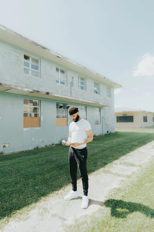 a woman standing in a yard with a headband on