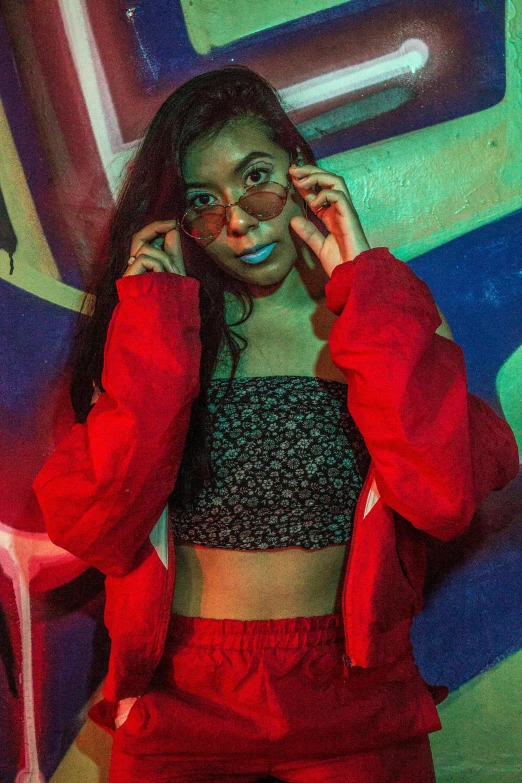 woman in red outfit talking on cell phone with mural behind her