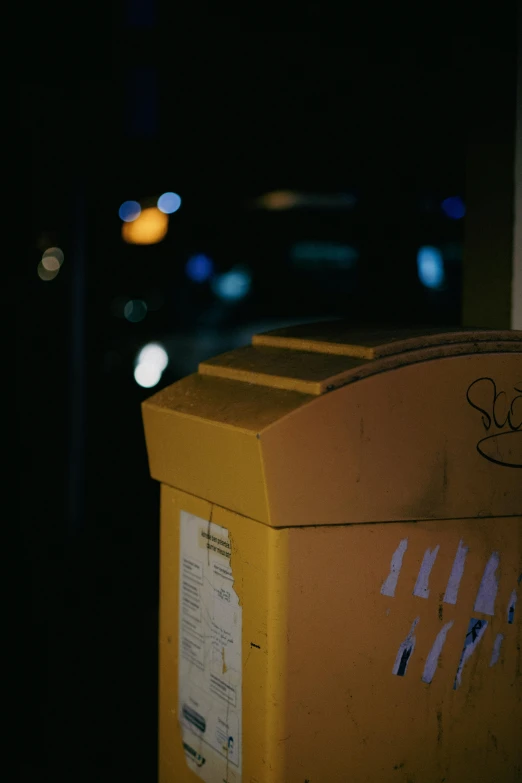 an empty yellow box at the end of a sidewalk