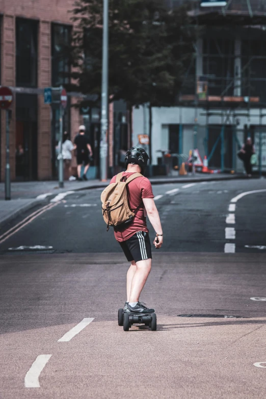 the man is riding his skateboard across the street