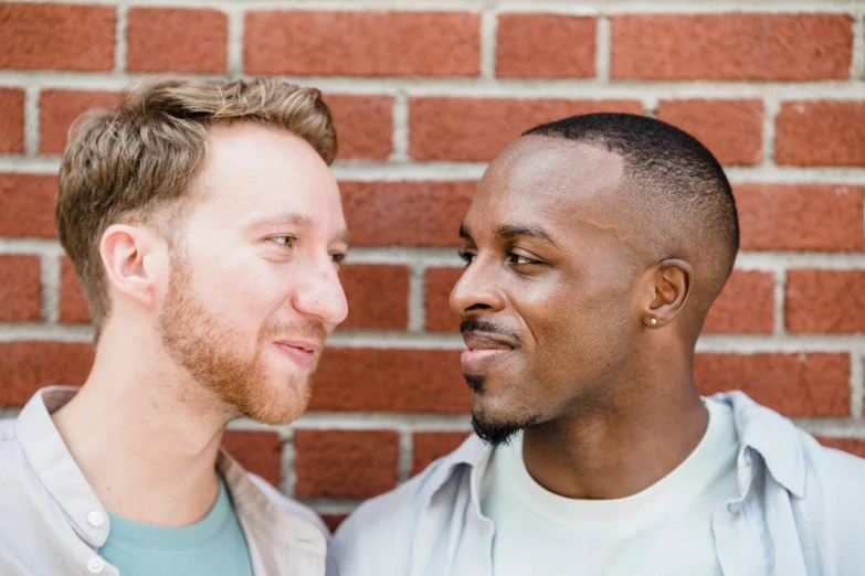 two men with shaved hair standing together