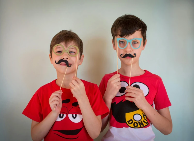 two boys wearing face paint with the faces of angry birds painted on them