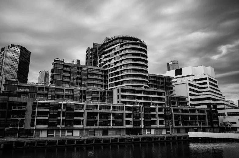 an apartment building with modern architecture under a cloudy sky