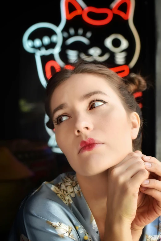 a woman sitting down wearing a cat dress