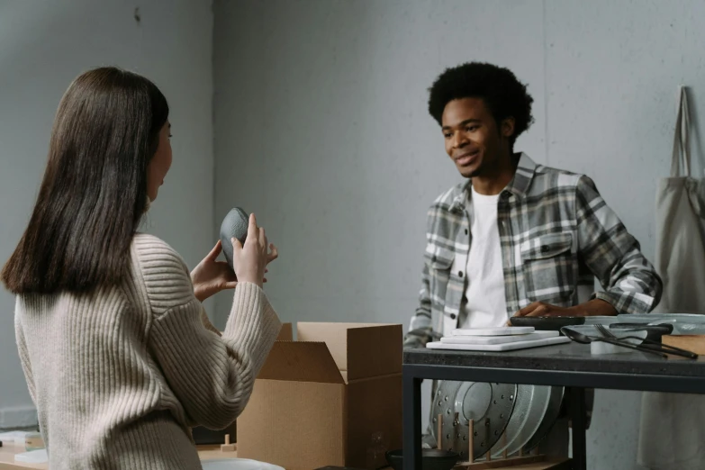 a woman holding soing up near a man in the office