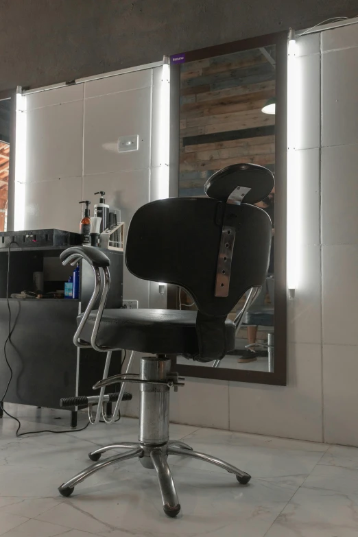 a salon chair is seen in front of a mirror