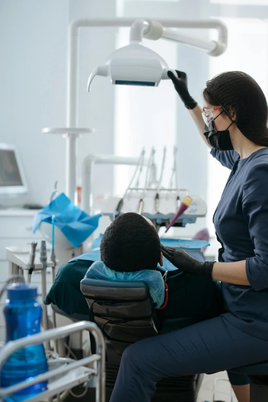 a dentist is performing a patient with a dental tool