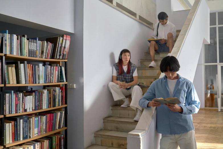 a man and woman standing in front of a book shelf