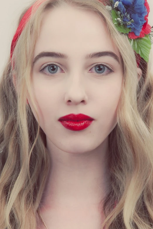 woman wearing a red rose headband in a po