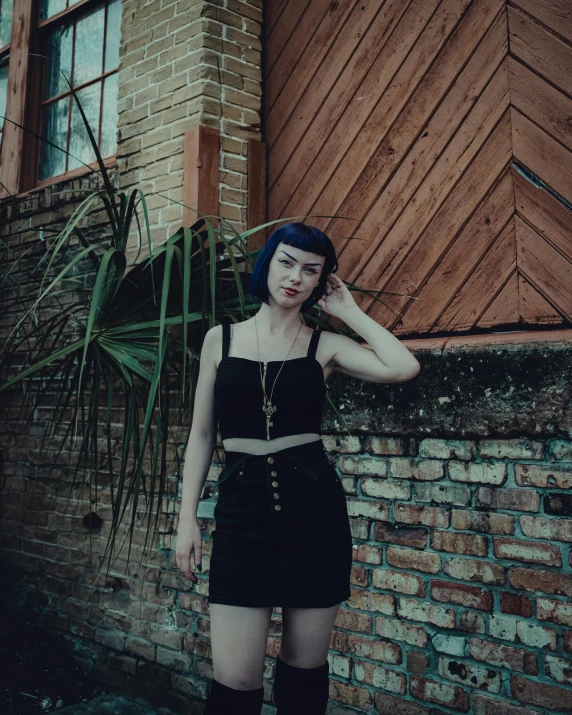 a woman standing on the side of a building