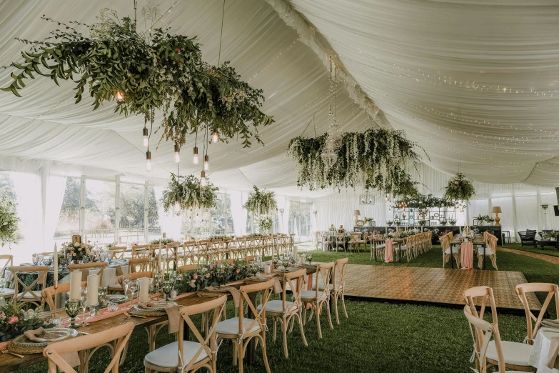 a big tent with several wooden chairs and tables