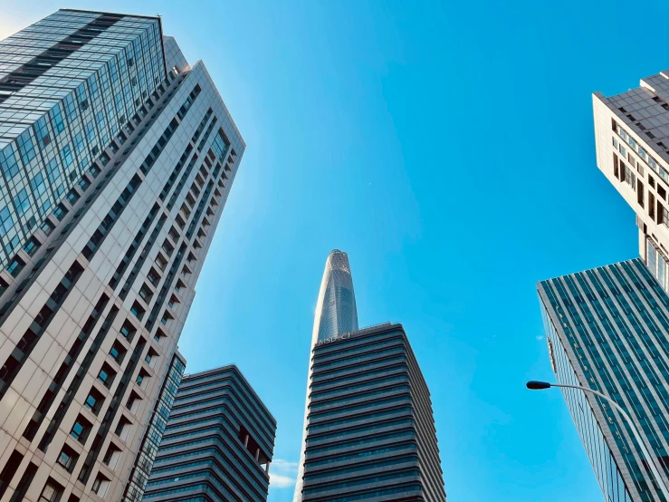 several large buildings are against a blue sky