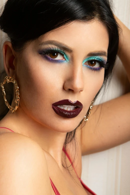 a woman is posing with makeup painted on her face