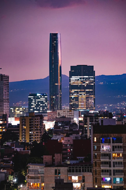 skyscrs on a city skyline at night