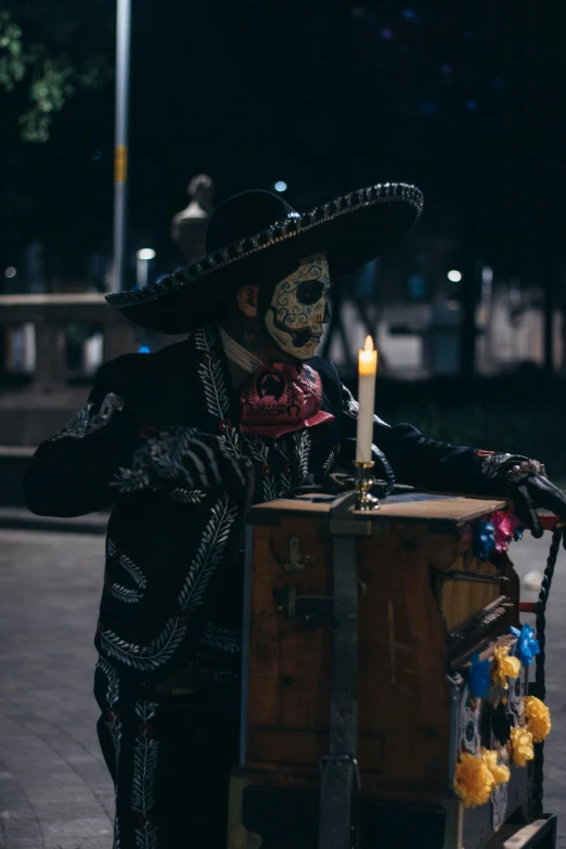 a costumed clown standing with his arm around a table