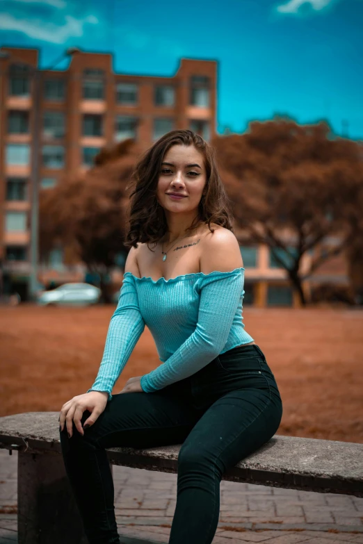 a woman sitting on a bench with long dark hair