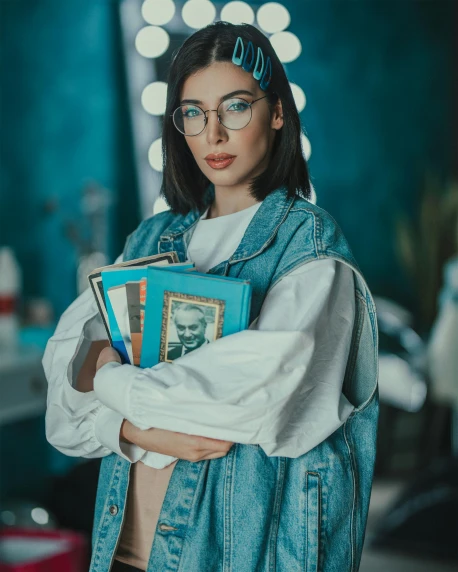 woman wearing glasses and holding books in a fashion editorial