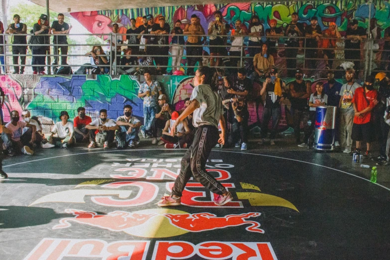 a man riding a skateboard on top of a floor next to a crowd