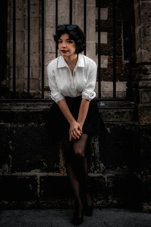 woman with black tights and a white shirt is posing