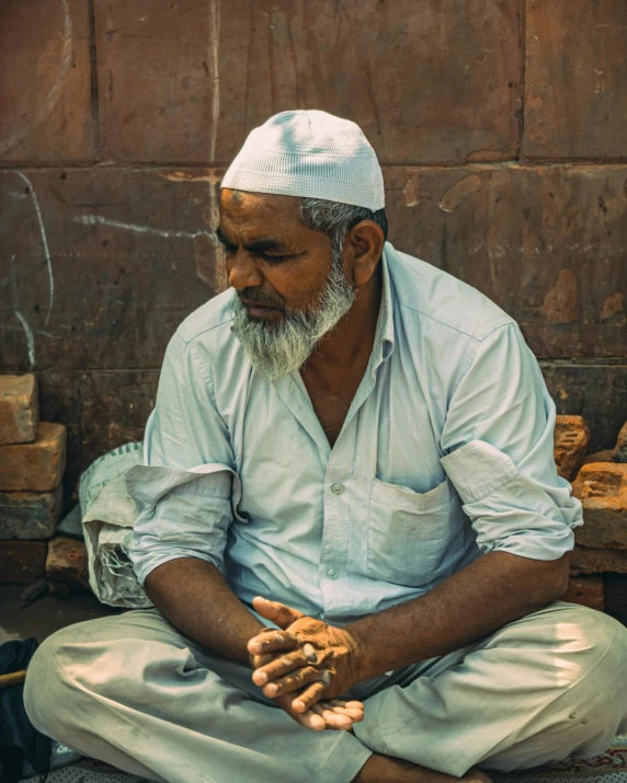 an old man sitting in front of a building