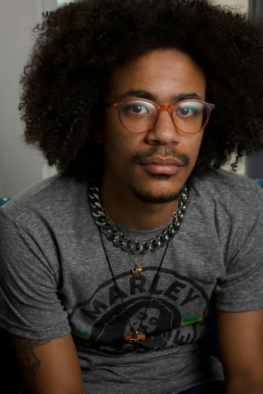 a close up of a person wearing glasses with a hair tie