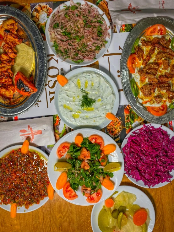 several plates with different food in them that are on a table