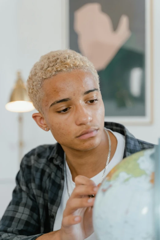 a boy looks at the map on a table