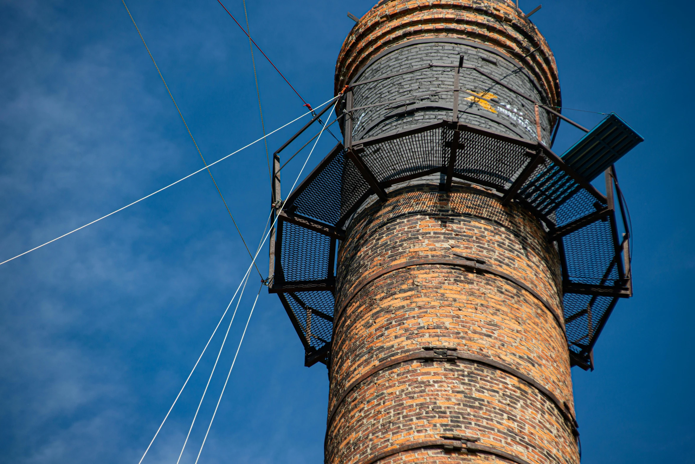 a brick tower with two air raiders hanging off of it's side