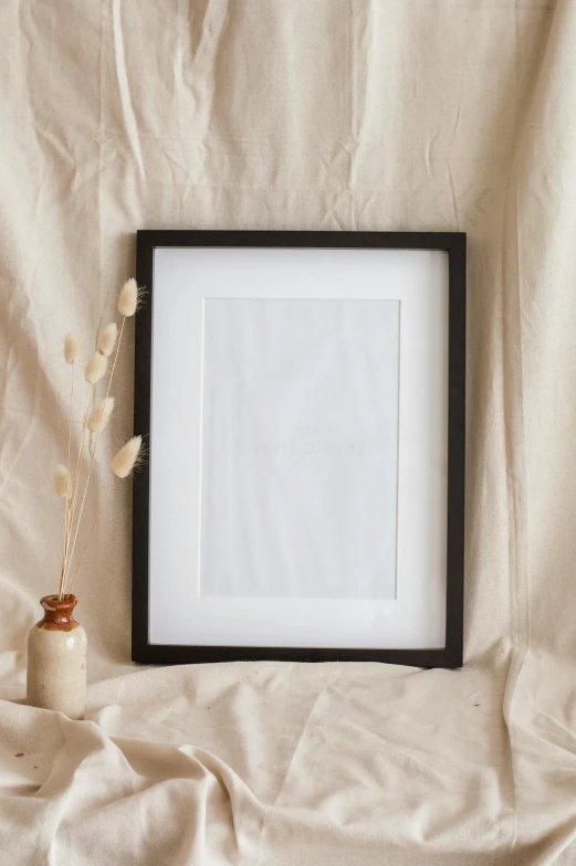 a white frame with flower buds on a light background