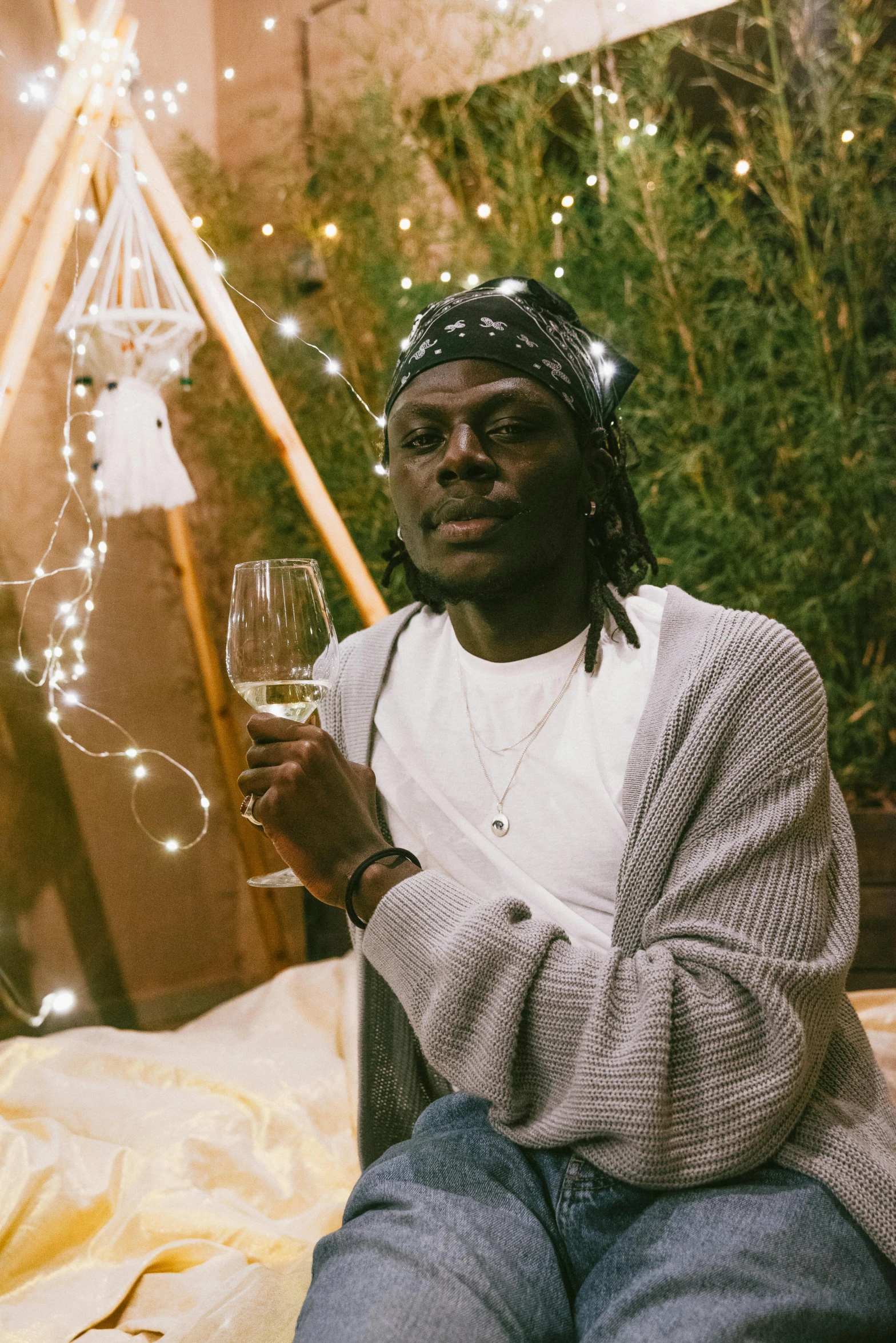 a man is sitting down holding a glass