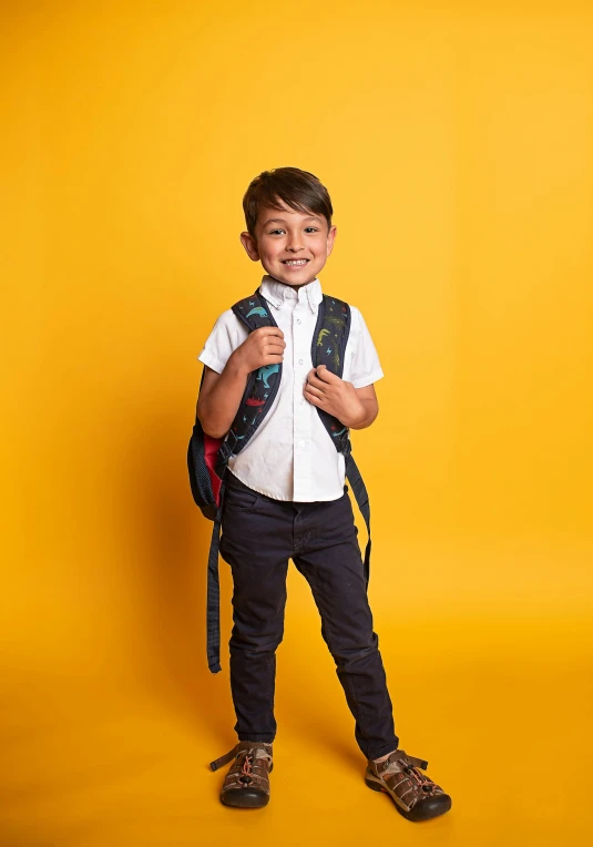  in school uniform smiling with backpack