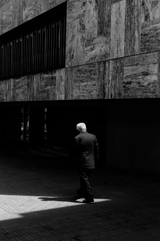 an older gentleman is standing on the street