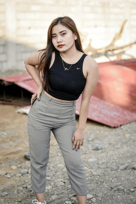 an asian woman with long brown hair and wearing a crop top