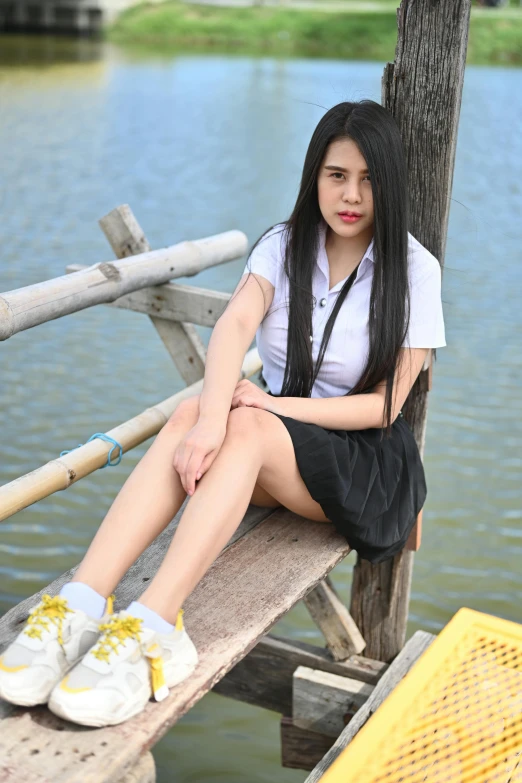 a woman sitting on top of a wooden bench