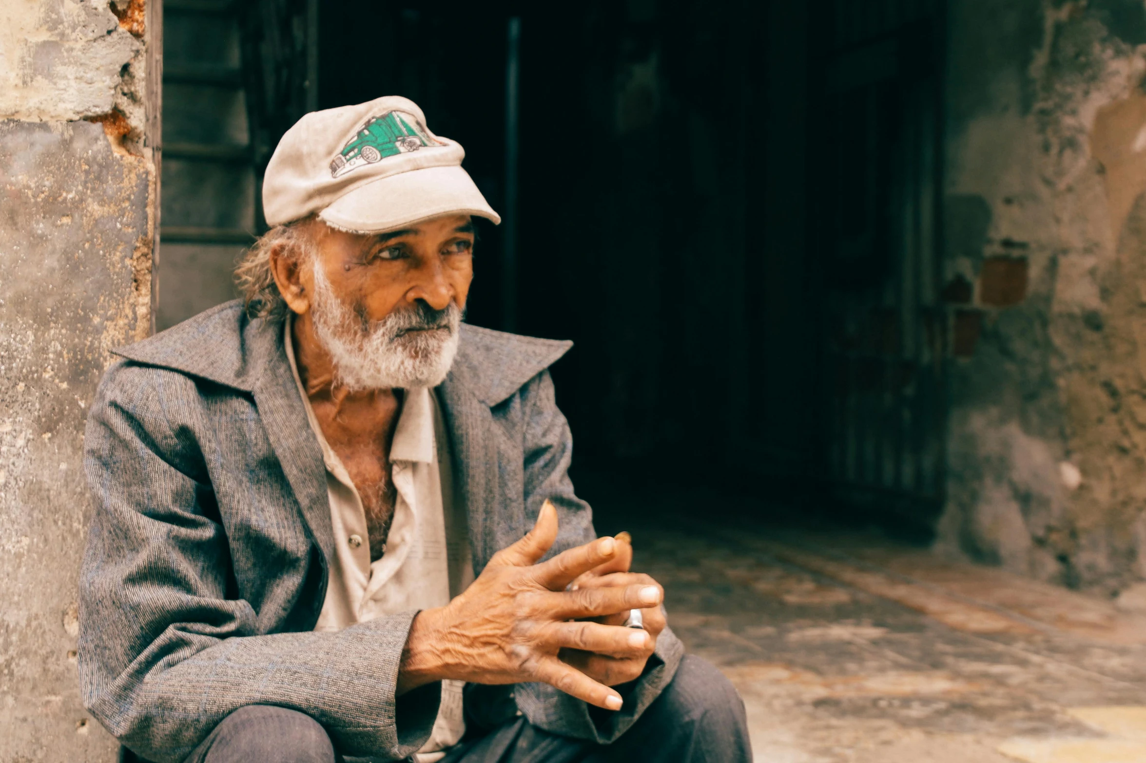 a man sitting on the ground in a dirty building