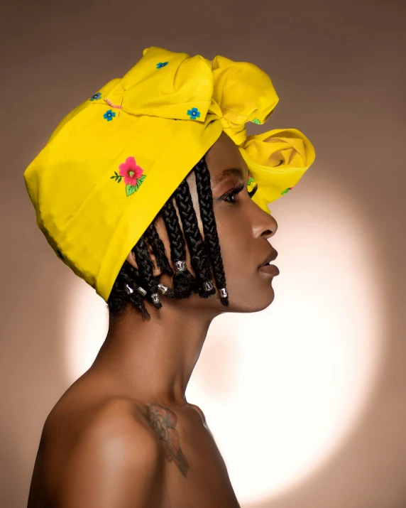 the woman is wearing a bright yellow hat with hair tied under her chin