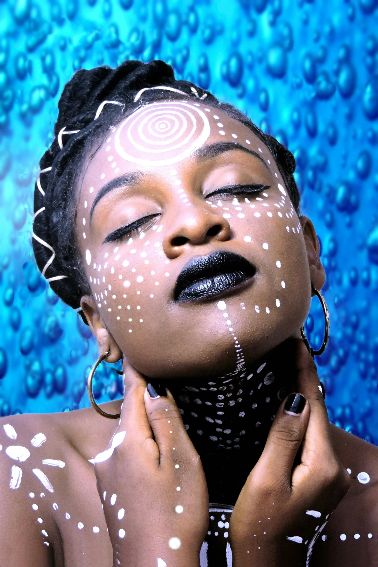 woman wearing silver rings and a blue background