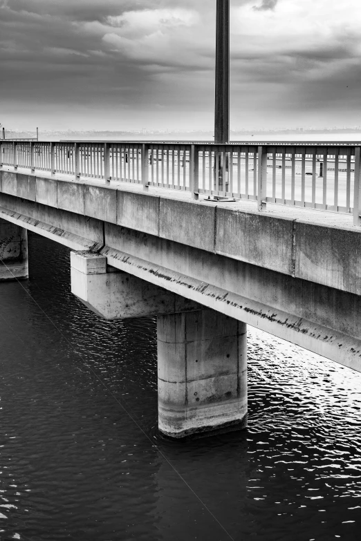 a lone passenger bridge is seen during a black and white po