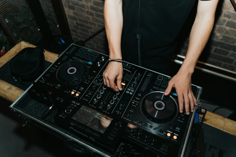 a dj standing in front of his equipment