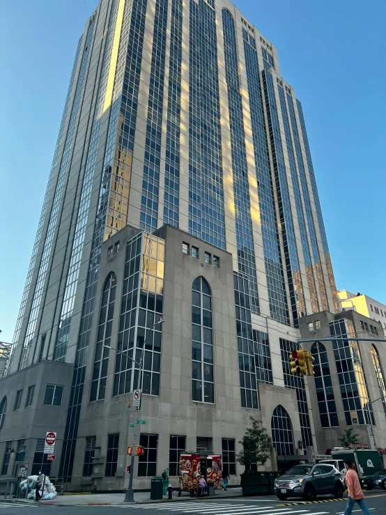 tall buildings on a street with cars and people