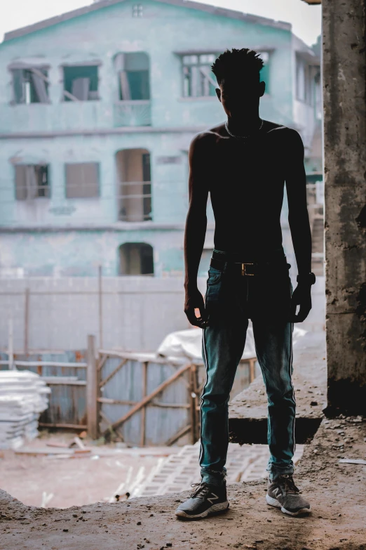 man looking out from outdoor structure, over city background