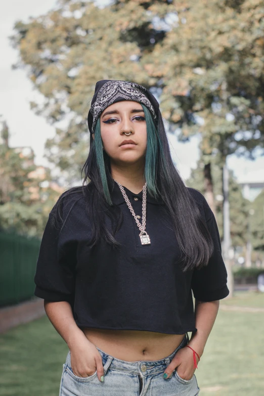 a girl is posing with a bandana on her head and a black shirt