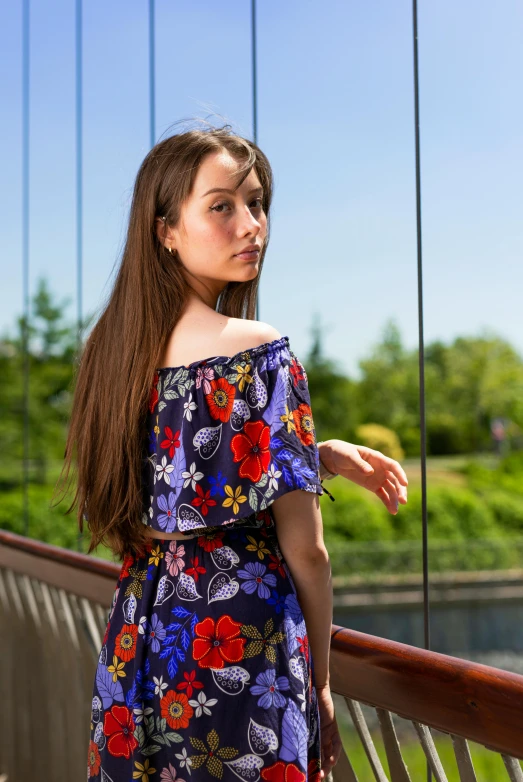 a young woman is standing on a bridge